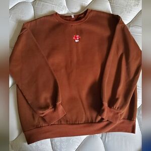 Cozy Brown Sweatshirt with Red Mushroom Accent